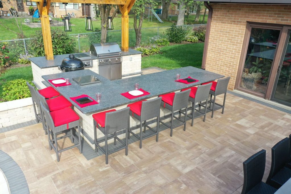 outdoor kitchen in patio with grill enclosure