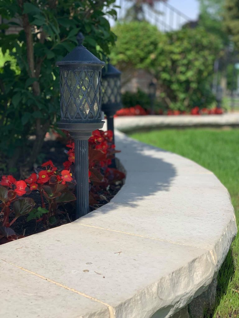 retaining wall with red flowers