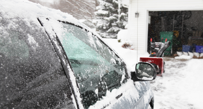 Car and Snowblower on Winter Blizzard Driveway