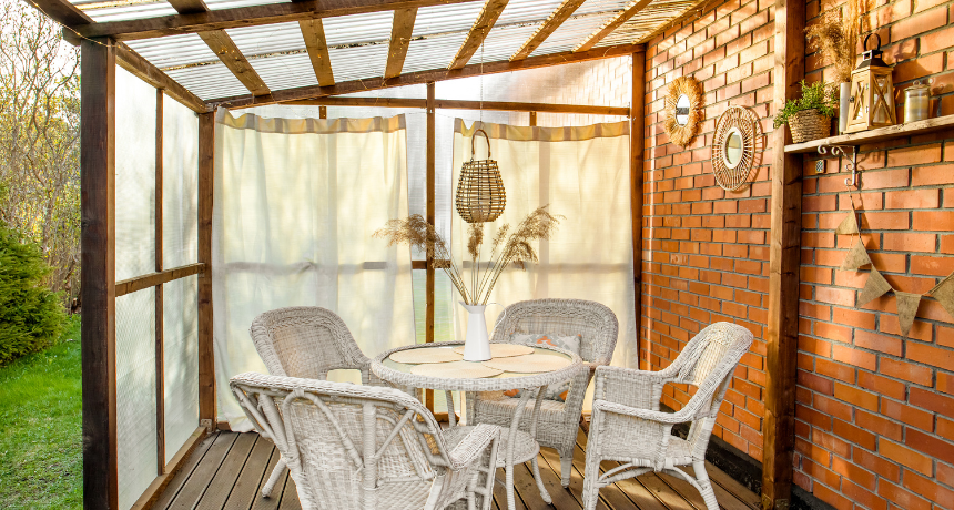 style home patio terrace with curtains and wicker, rattan, reed decorations.