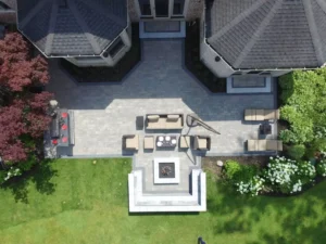best-time-install-paver-patio-chicago-suburbs Finished paver patio with fire pit and seating, the result of good timing on installation in the Chicago suburbs