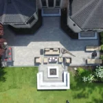 Finished paver patio with fire pit and seating, the result of good timing on installation in the Chicago suburbs